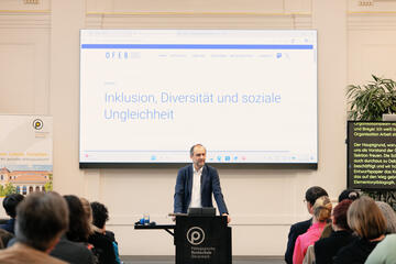 Ein Mann steht am Sprechpult